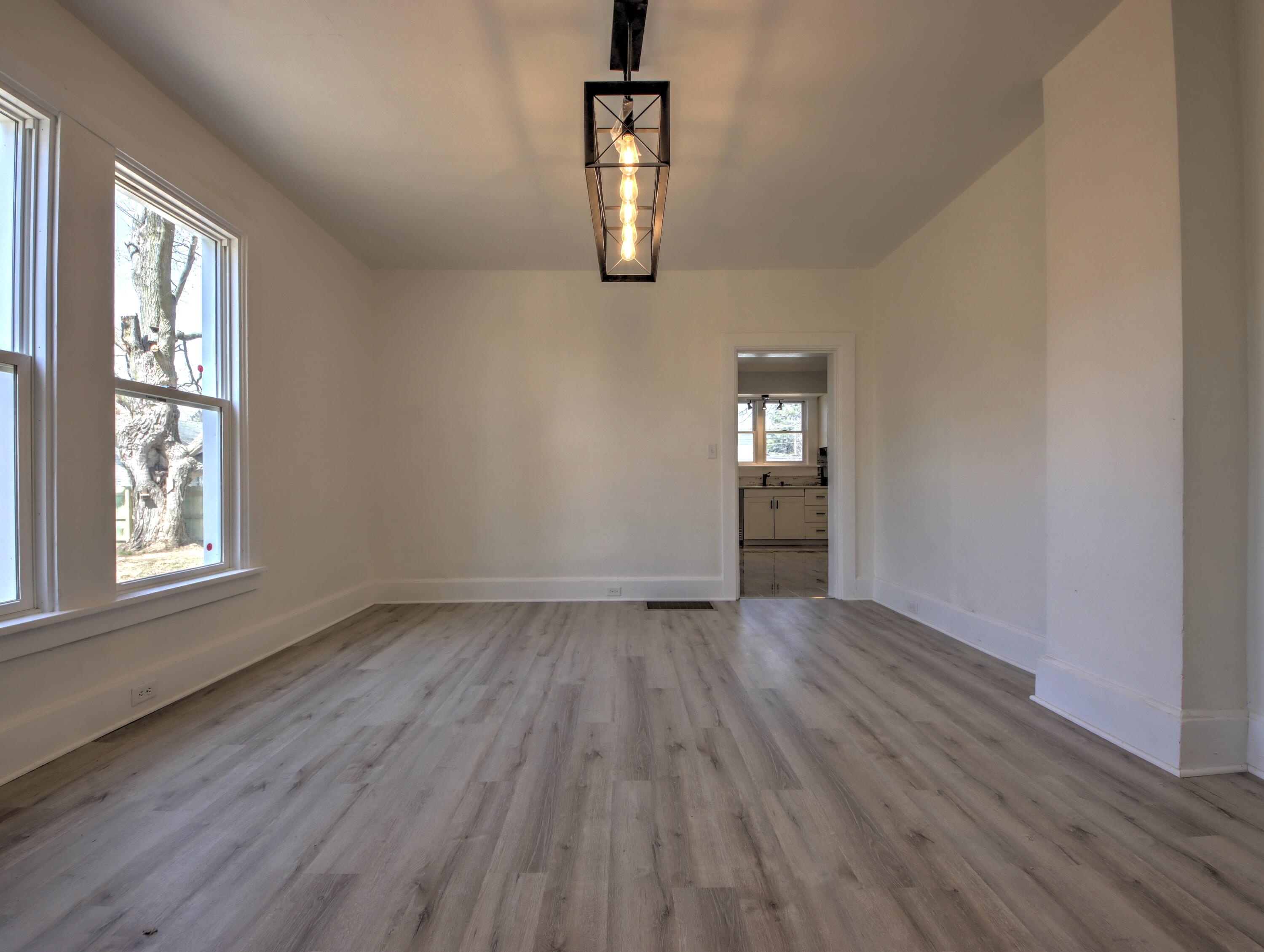 508 F Street La Porte, IN 46350 - Photo 13 of 52 an empty room with wooden floor cabinet and windows
