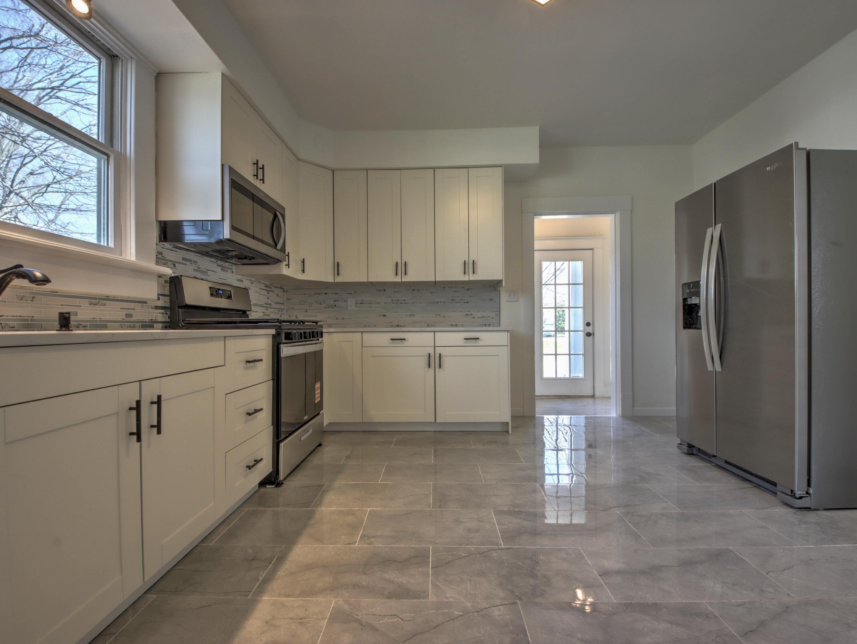 508 F Street La Porte, IN 46350 - Photo 14 of 52 a kitchen with white cabinets stainless steel appliances and a window