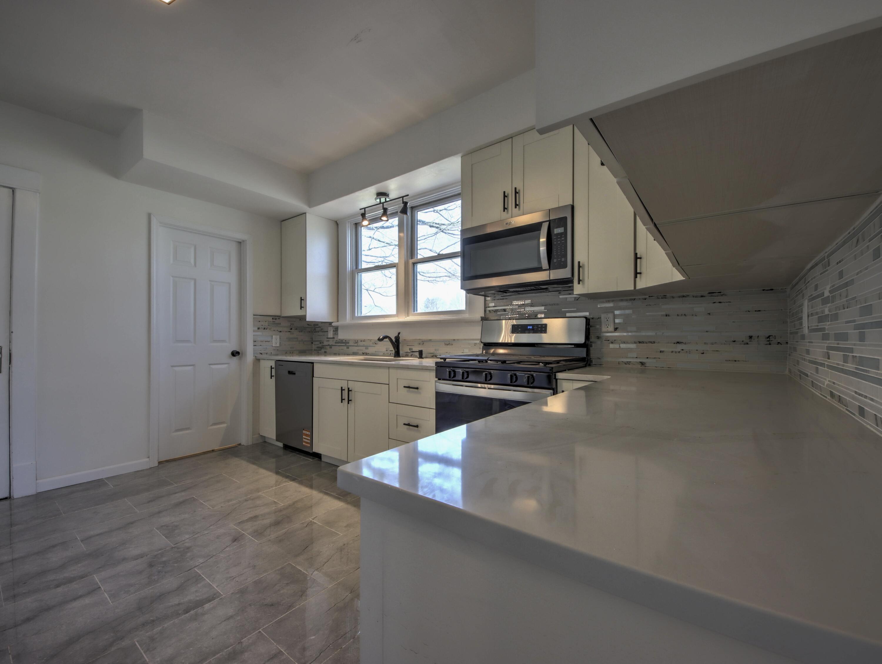 508 F Street La Porte, IN 46350 - Photo 15 of 52 a kitchen with stainless steel appliances a sink a stove top oven a counter space and cabinets