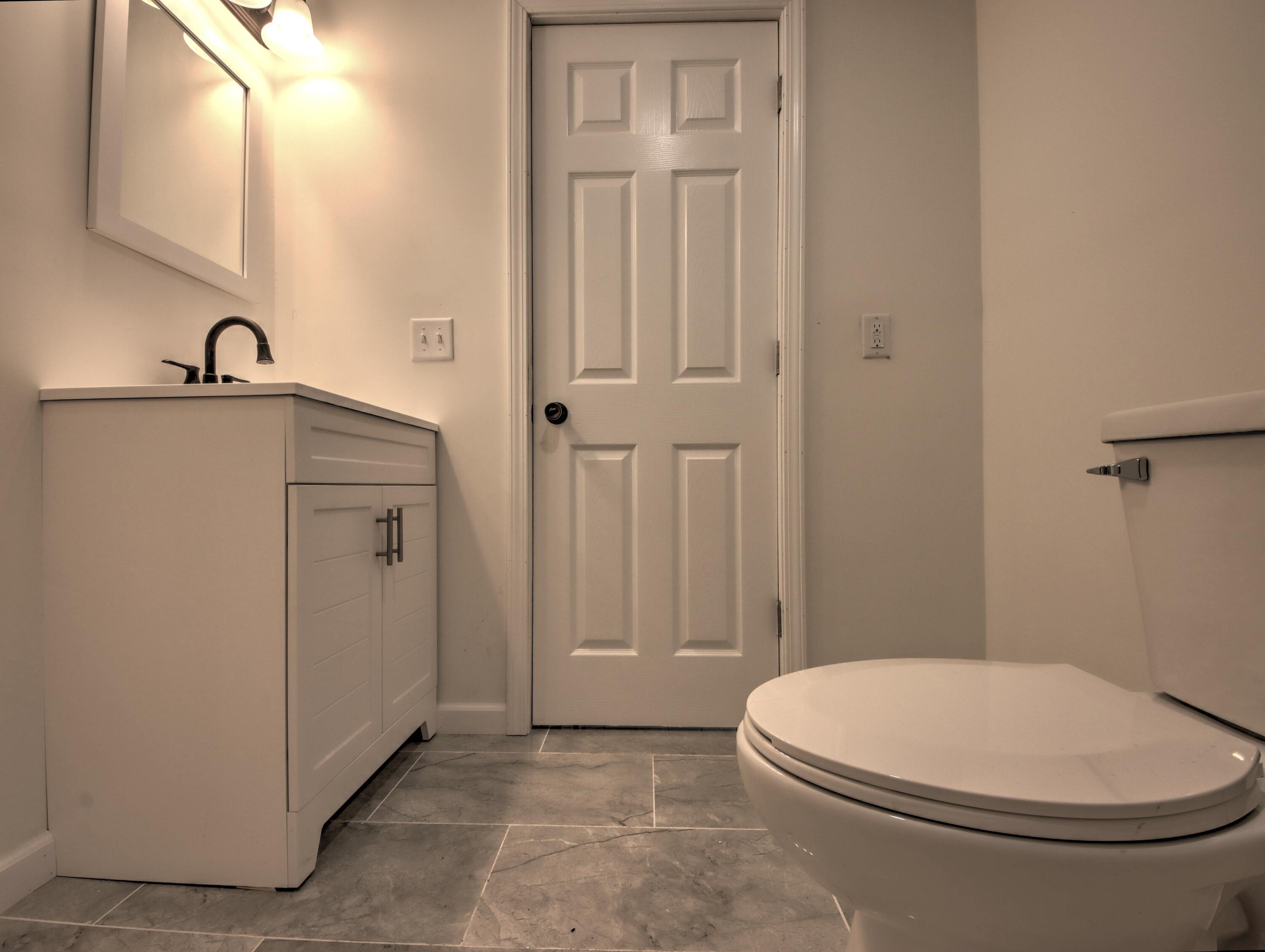 508 F Street La Porte, IN 46350 - Photo 18 of 52 a bathroom with a toilet a sink a vanity and mirror