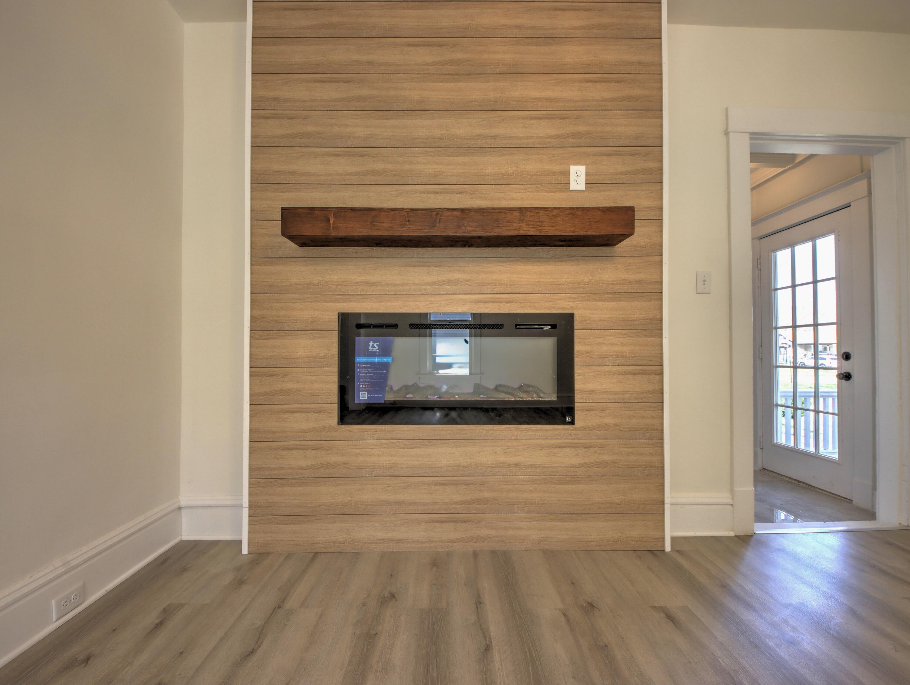 508 F Street La Porte, IN 46350 - Photo 8 of 52 a living room with stainless steel appliances wooden floor and a fireplace