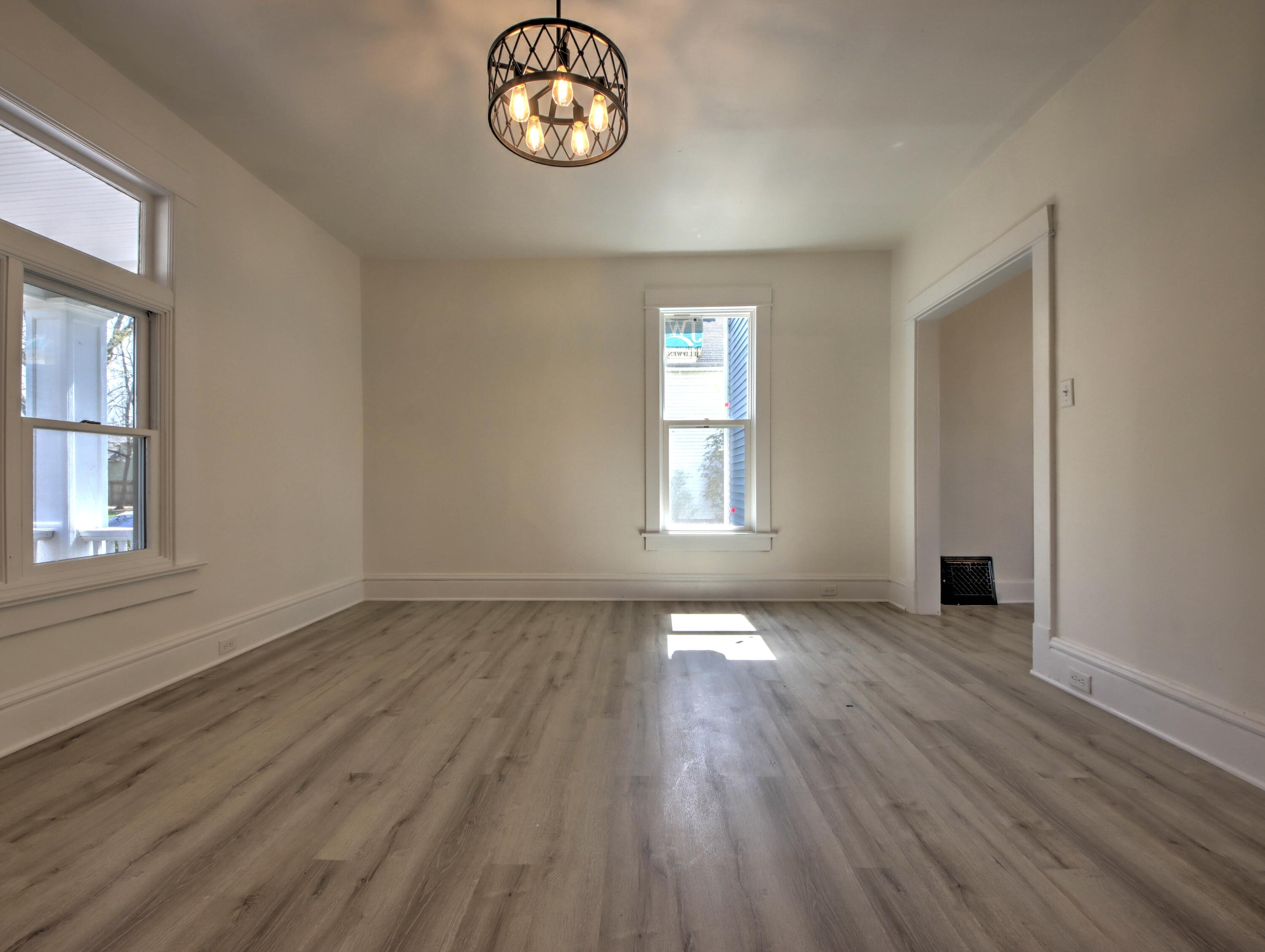 508 F Street La Porte, IN 46350 - Photo 9 of 52 an empty room with wooden floor and windows
