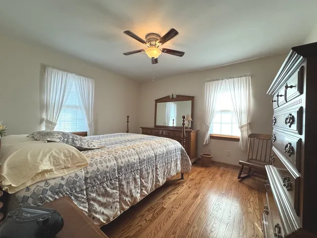 a bedroom with a large bed and a window