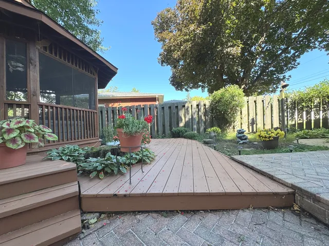 a view of backyard with deck and outdoor seating