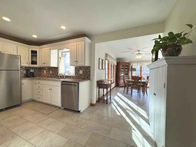 a kitchen with a refrigerator and a sink