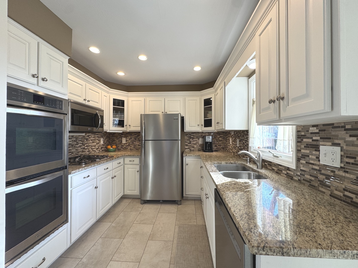 13 Erin Lane Kankakee, IL 60901 - Photo 6 of 34 a kitchen with refrigerator a stove top oven and cabinets