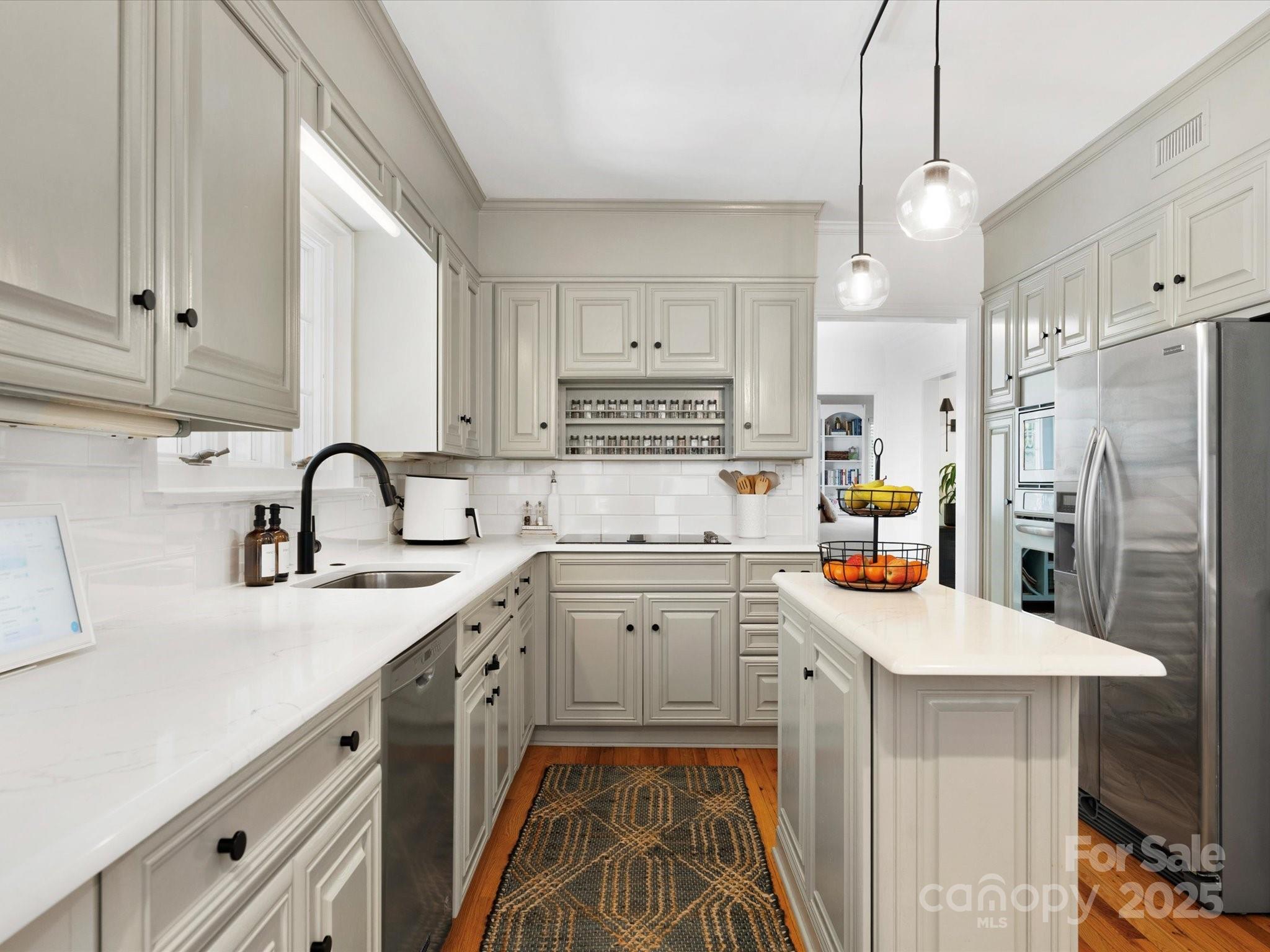 1927 South Wendover Road Charlotte, NC 28211 - Photo 4 of 36 a kitchen with stainless steel appliances a sink stove and refrigerator