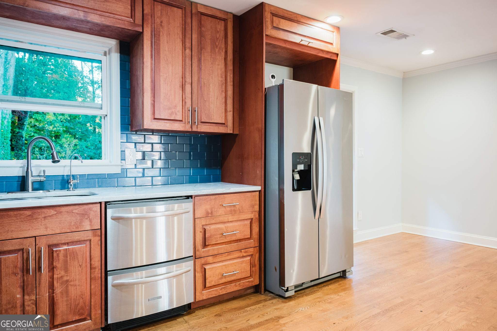 893 Slash Pine Road Forest Park, GA 30297 - Photo 11 of 38 a kitchen with granite countertop stainless steel appliances a refrigerator and cabinets