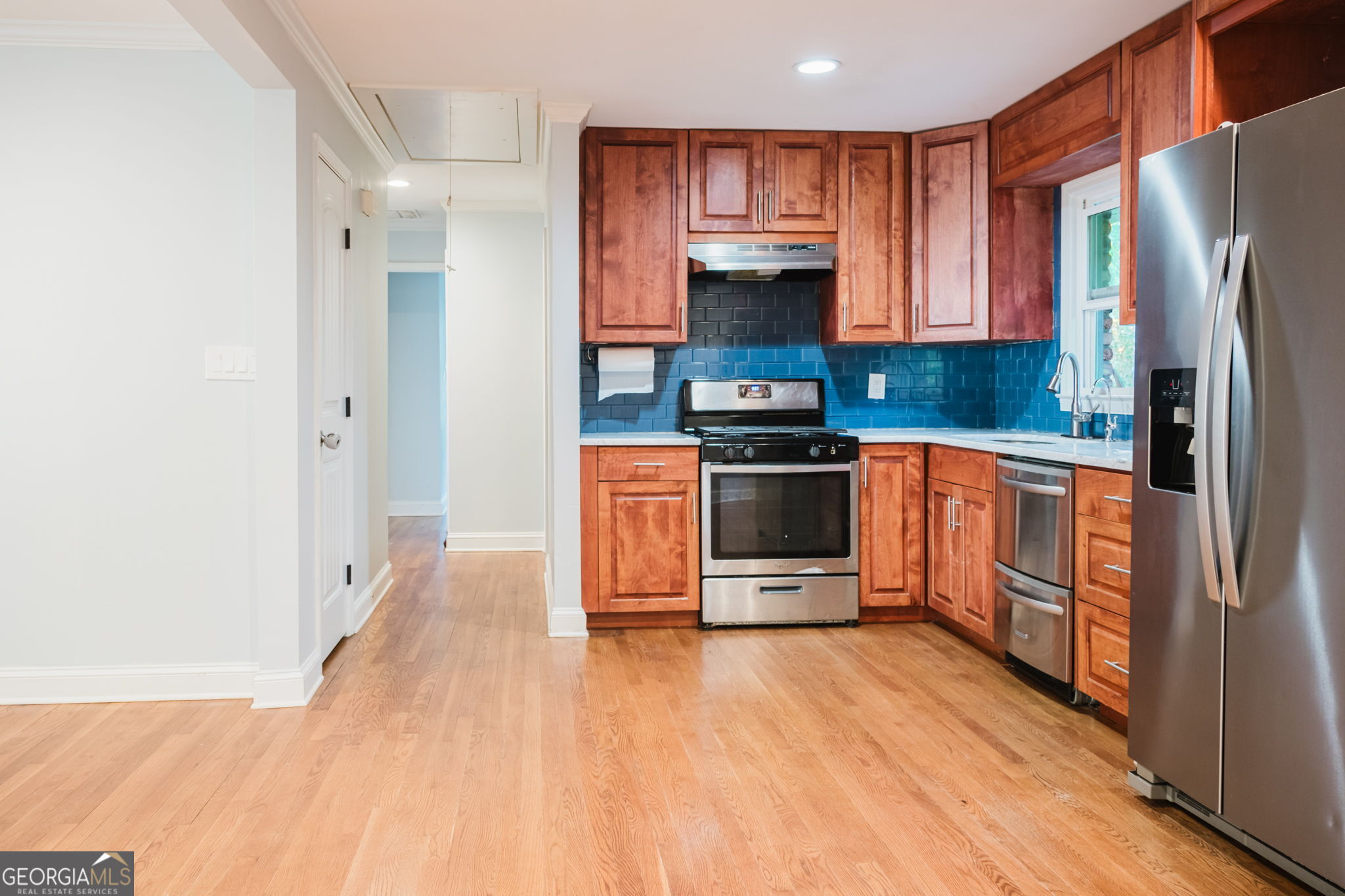 893 Slash Pine Road Forest Park, GA 30297 - Photo 13 of 38 a kitchen with stainless steel appliances a stove refrigerator and a microwave