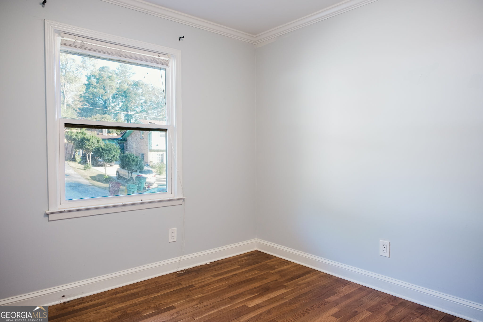 893 Slash Pine Road Forest Park, GA 30297 - Photo 15 of 38 a view of an empty room with wooden floor and a window