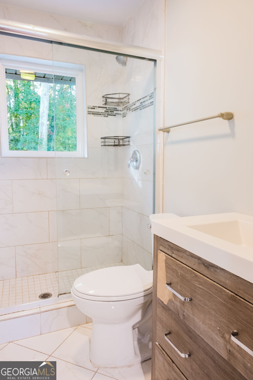 893 Slash Pine Road Forest Park, GA 30297 - Photo 17 of 38 a bathroom with a toilet and a shower