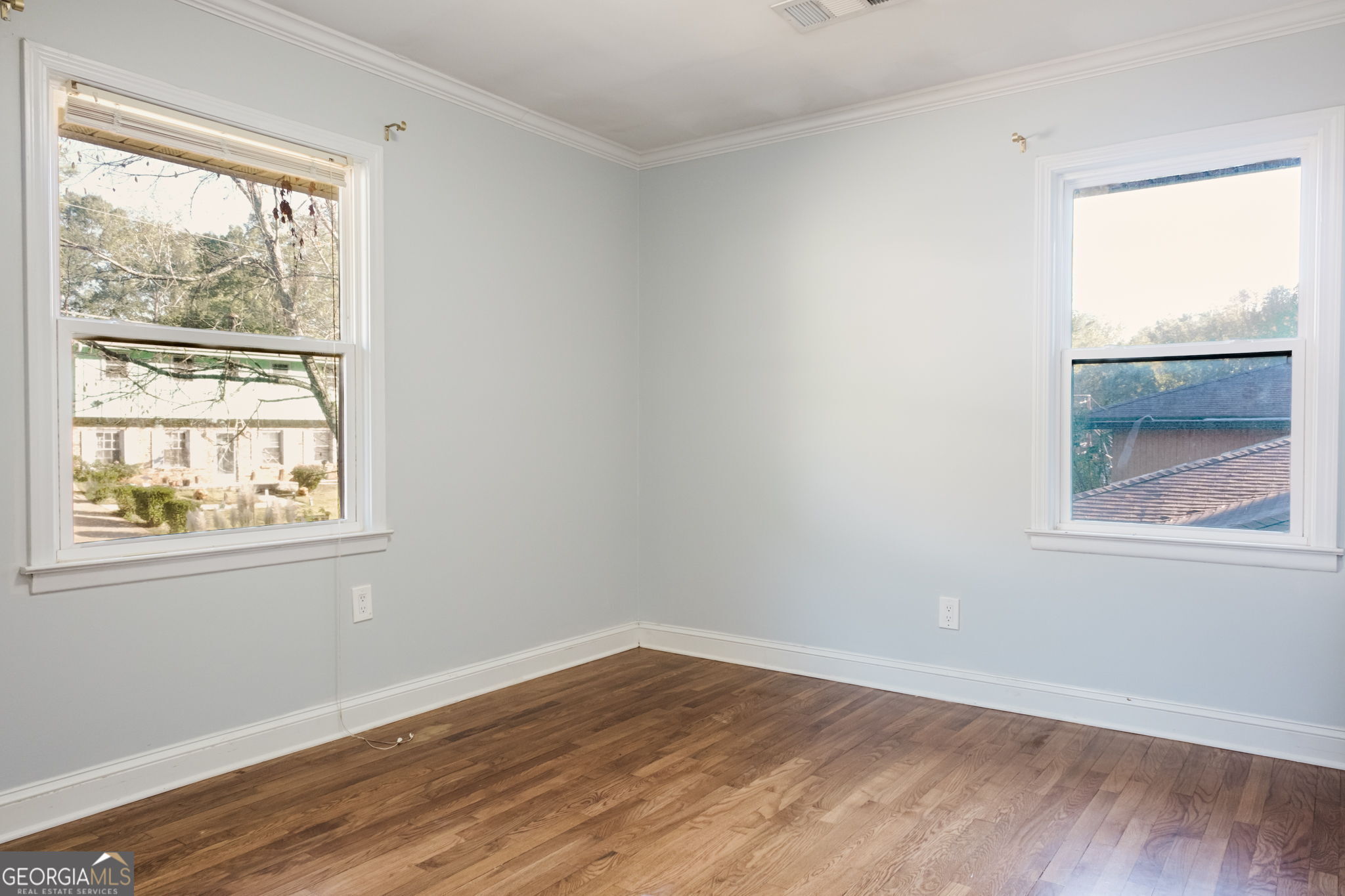 893 Slash Pine Road Forest Park, GA 30297 - Photo 19 of 38 an empty room with wooden floor and windows