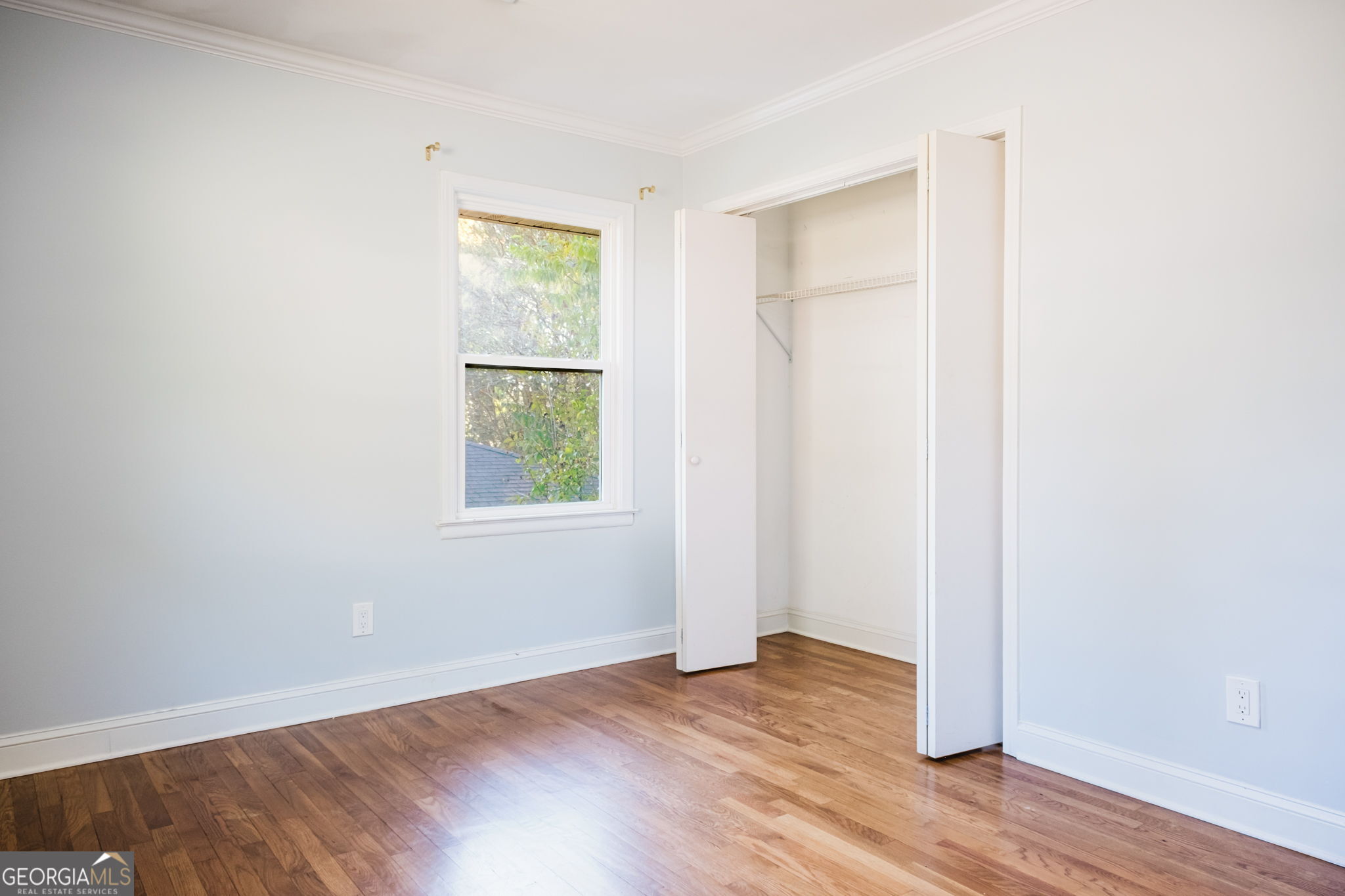 893 Slash Pine Road Forest Park, GA 30297 - Photo 21 of 38 an empty room with wooden floor and windows