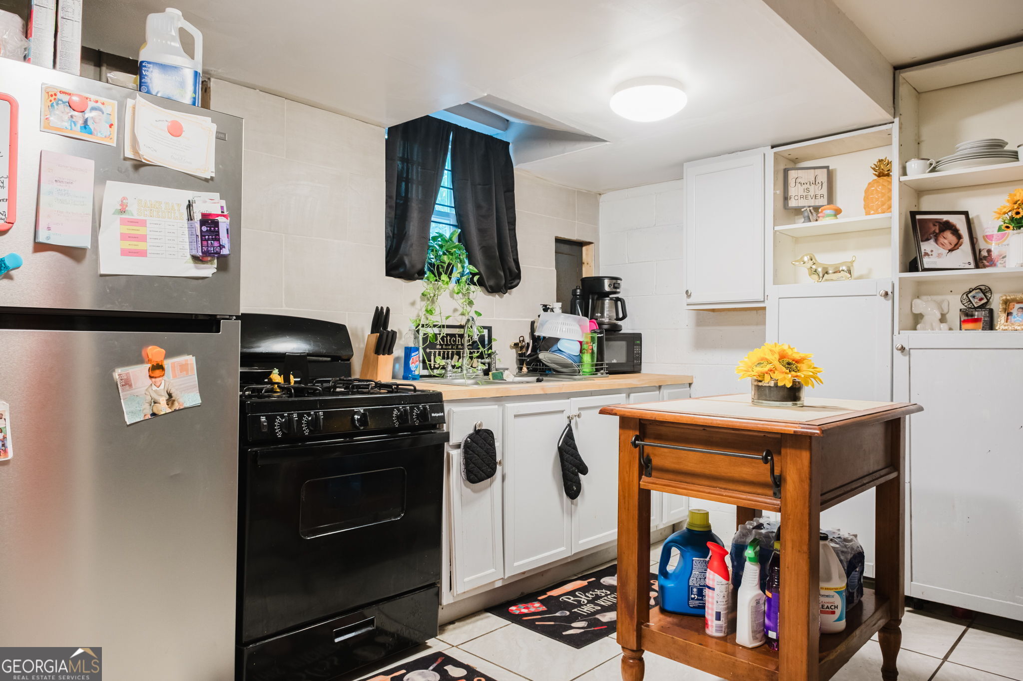 893 Slash Pine Road Forest Park, GA 30297 - Photo 35 of 38 a kitchen with stainless steel appliances a stove cabinets and a counter top space
