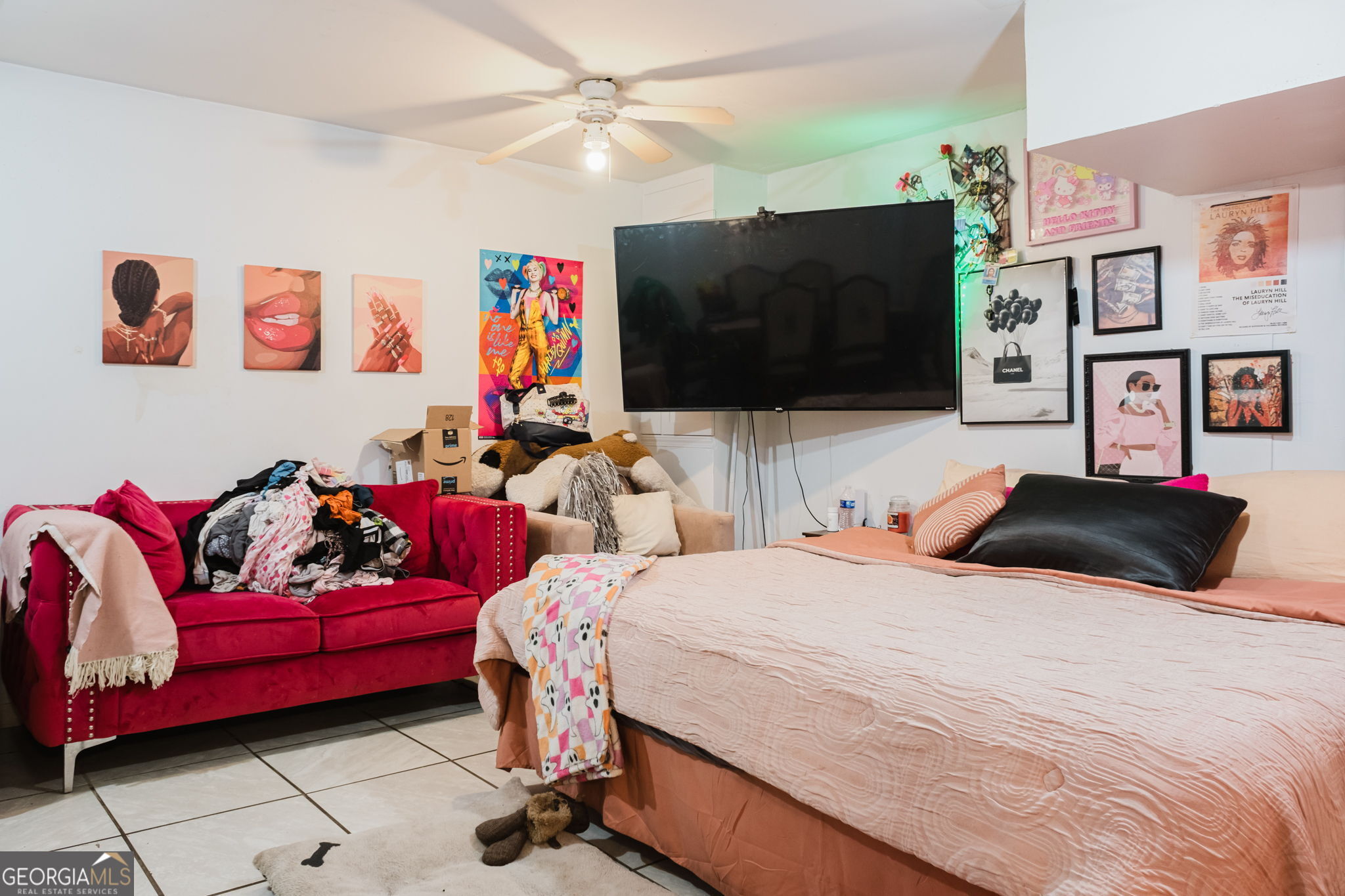 893 Slash Pine Road Forest Park, GA 30297 - Photo 36 of 38 a bedroom with a bed and a flat screen tv