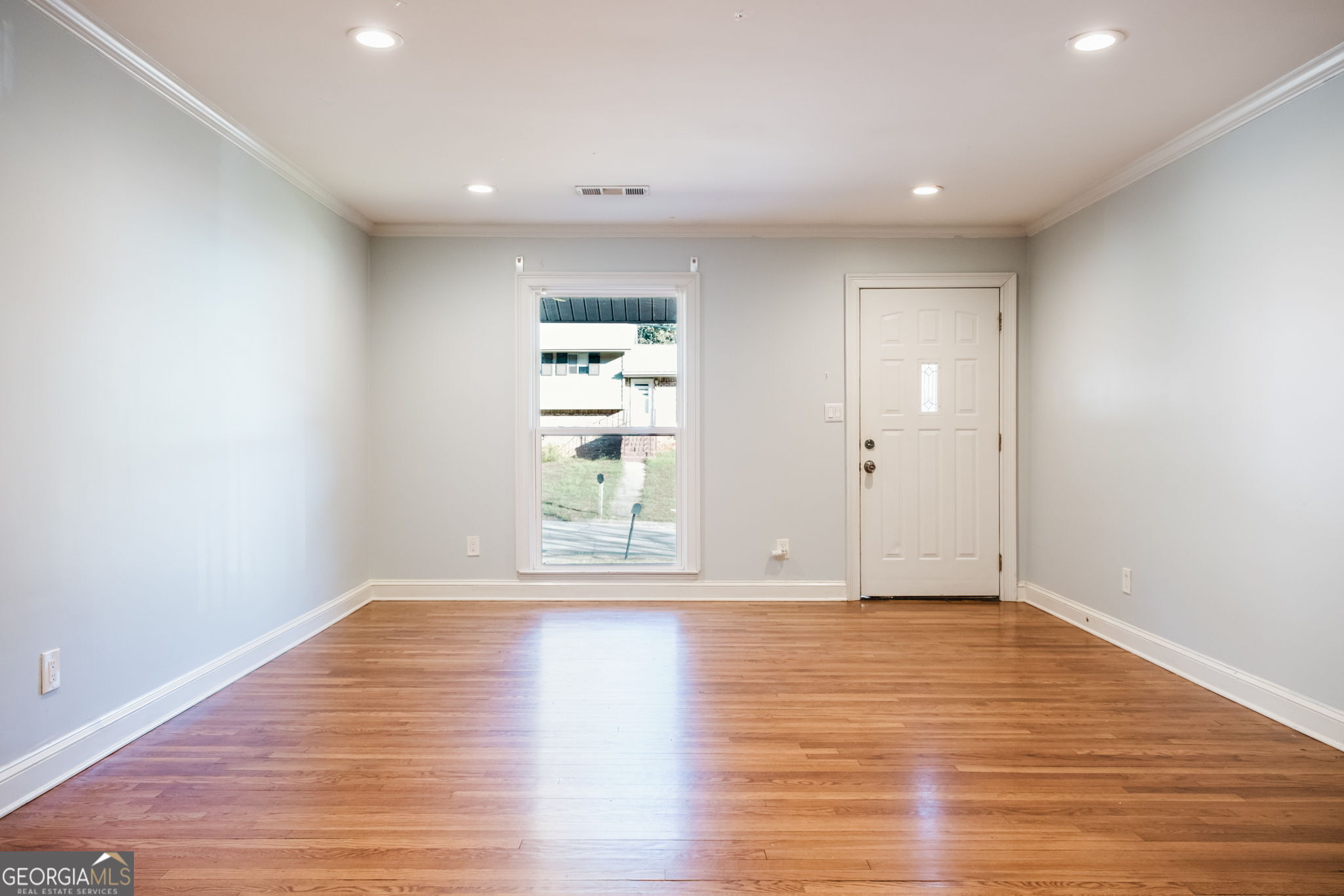 893 Slash Pine Road Forest Park, GA 30297 - Photo 8 of 38 a view of empty room with wooden floor and fan