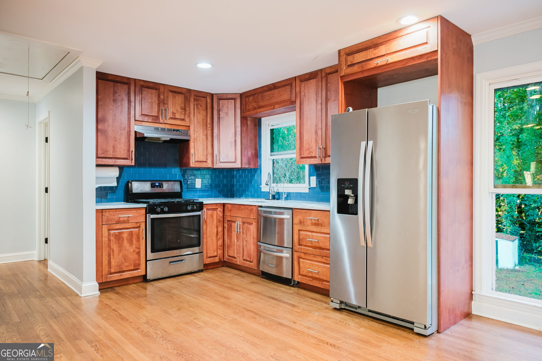 893 Slash Pine Road Forest Park, GA 30297 - Photo 10 of 38 a kitchen with stainless steel appliances a refrigerator sink and microwave
