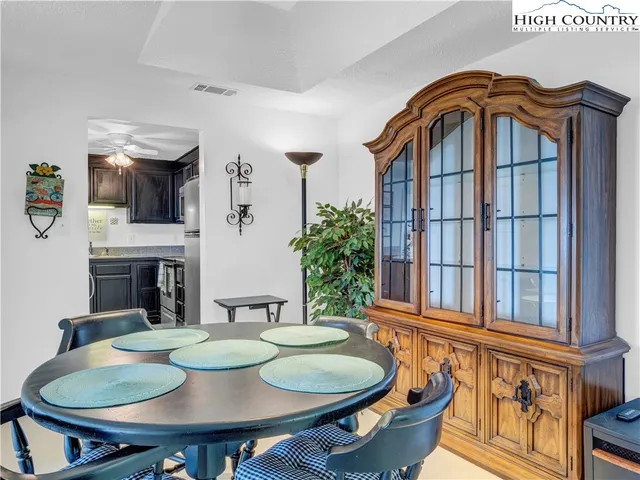 a dining room with furniture a rug and wooden floor