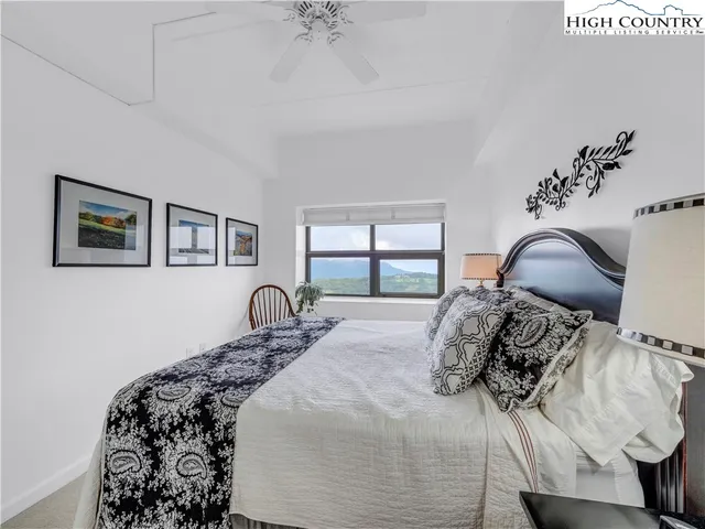 a bedroom with a bed and a chair