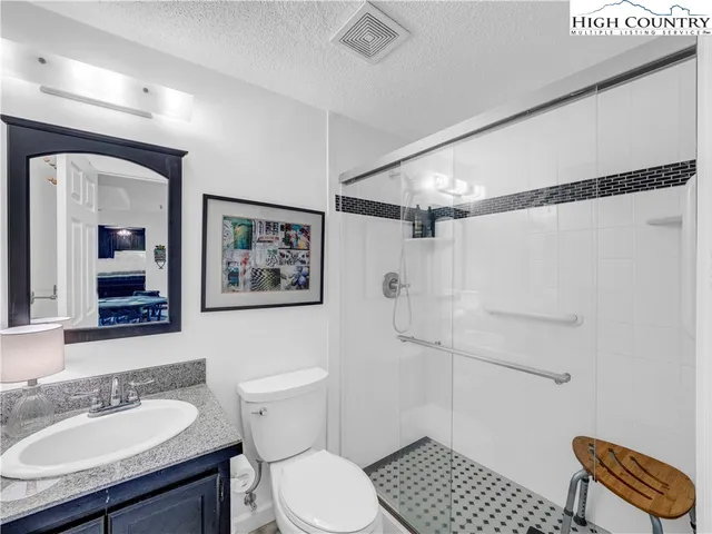 a bedroom with a bed and a tv on the dresser