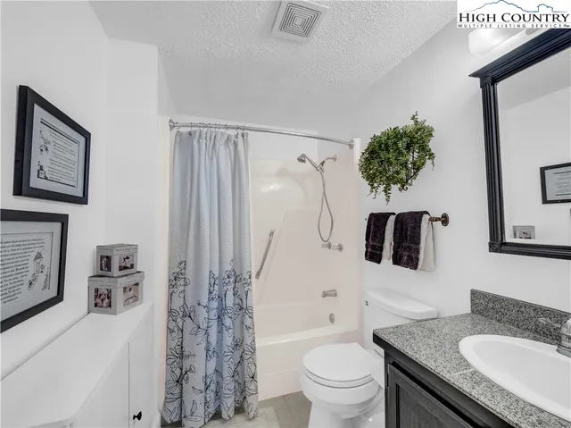 a living room with furniture and flower pot