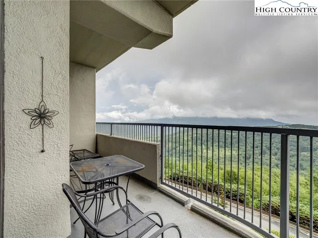 a balcony with table and chairs