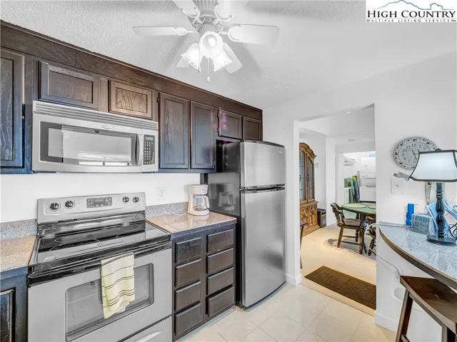 a kitchen with stainless steel appliances a stove microwave and refrigerator