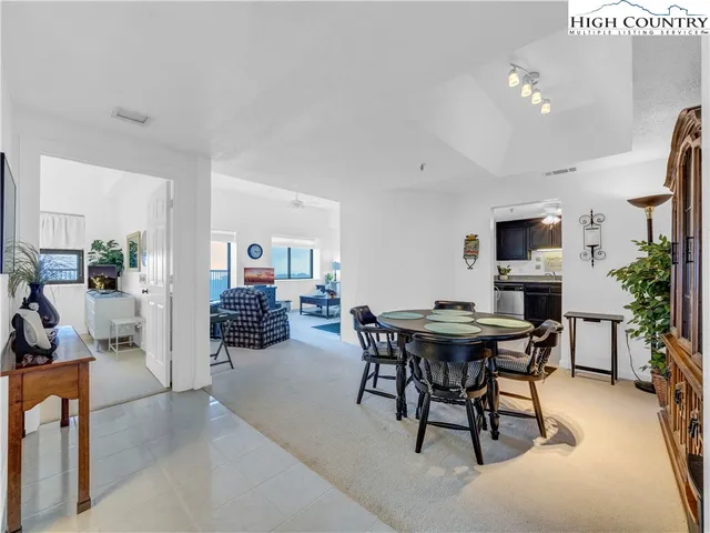 a view of a dining room with furniture and a livingroom