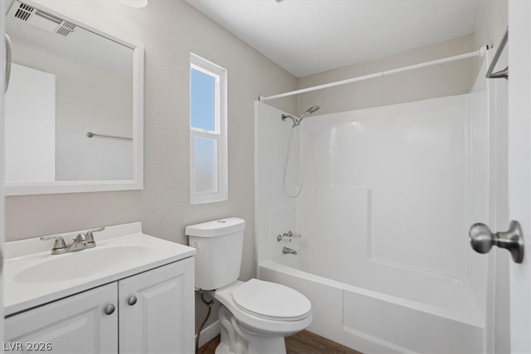 283 Aztec Lane Henderson, NV 89015 - Photo 18 of 21 A well-lit primary bathroom features a shower-and-tub combination and a single vanity with ample storage.