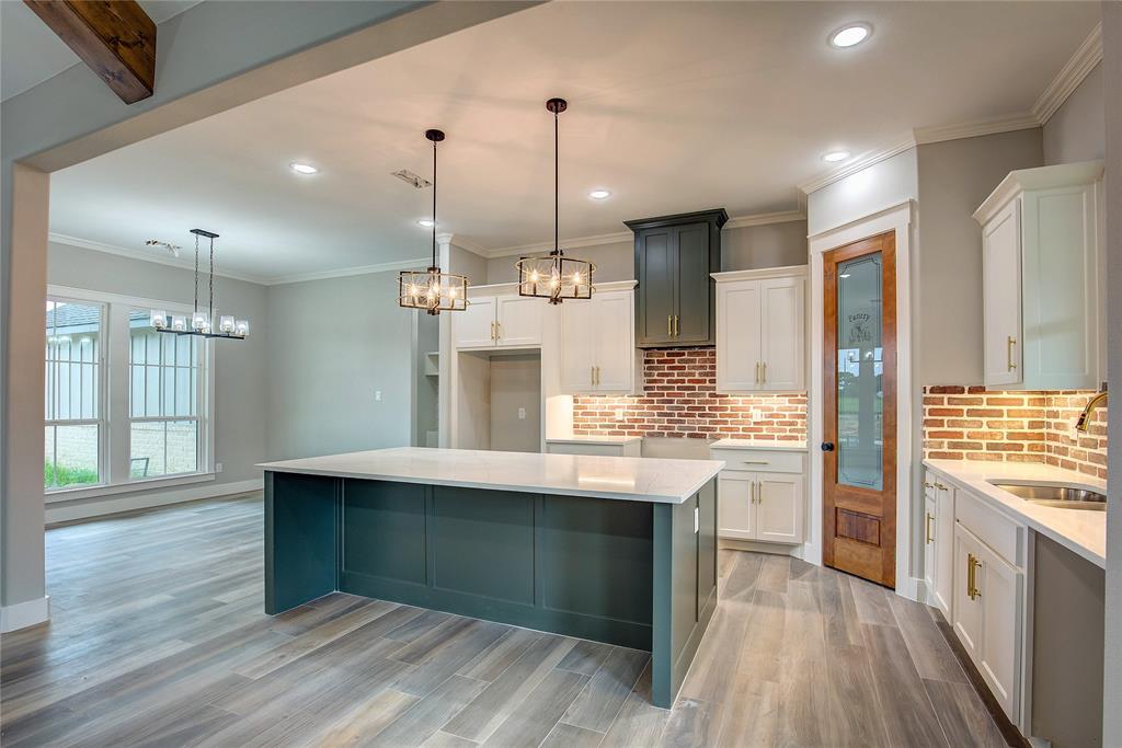 405 Door Key Ranch Road Trinidad, TX 75163 - Photo 7 of 28 Kitchen featuring light hardwood / wood-style floors, sink, a center island, and white cabinets