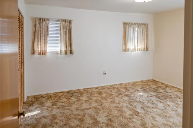 a room with a bed and wooden floor