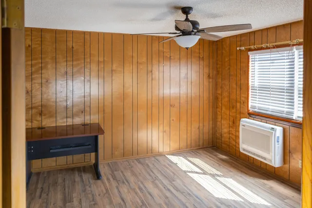 a view of a room with wooden floor and windows