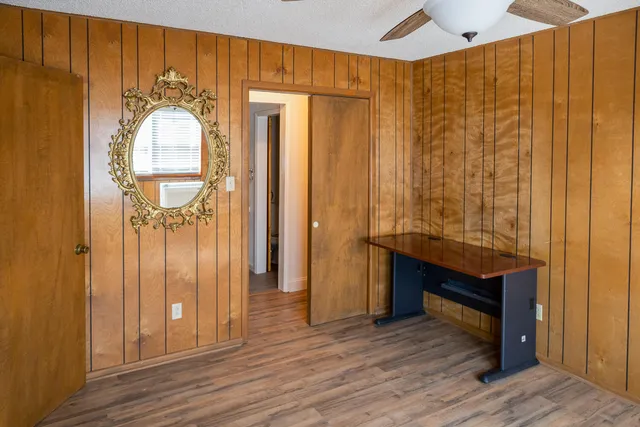 a view of a hallway with wooden floor and front door