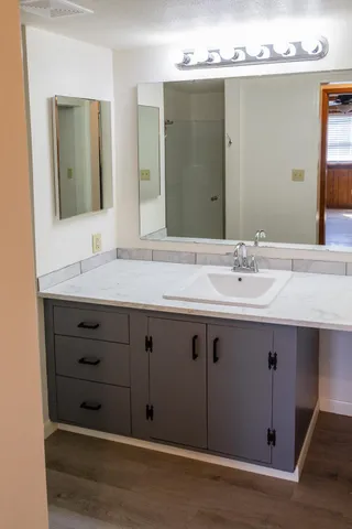 a bathroom with a sink double vanity and a mirror