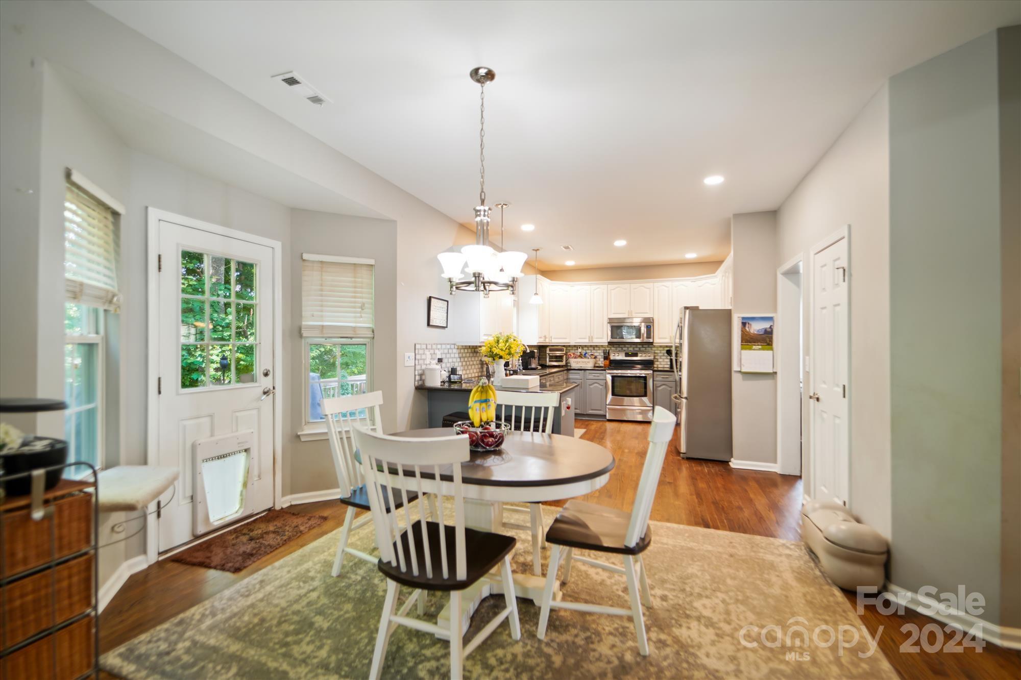 504 Haley Court Fort Mill, SC 29708 - Photo 5 of 31 a dining room with furniture a chandelier and wooden floor