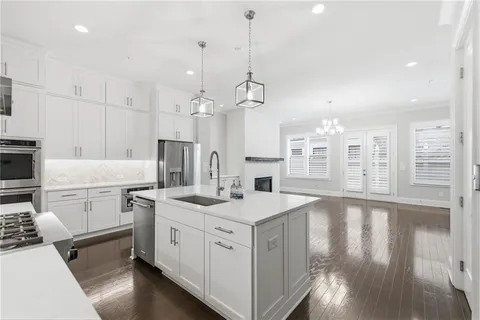 a kitchen that has a lot of cabinets in it and appliances