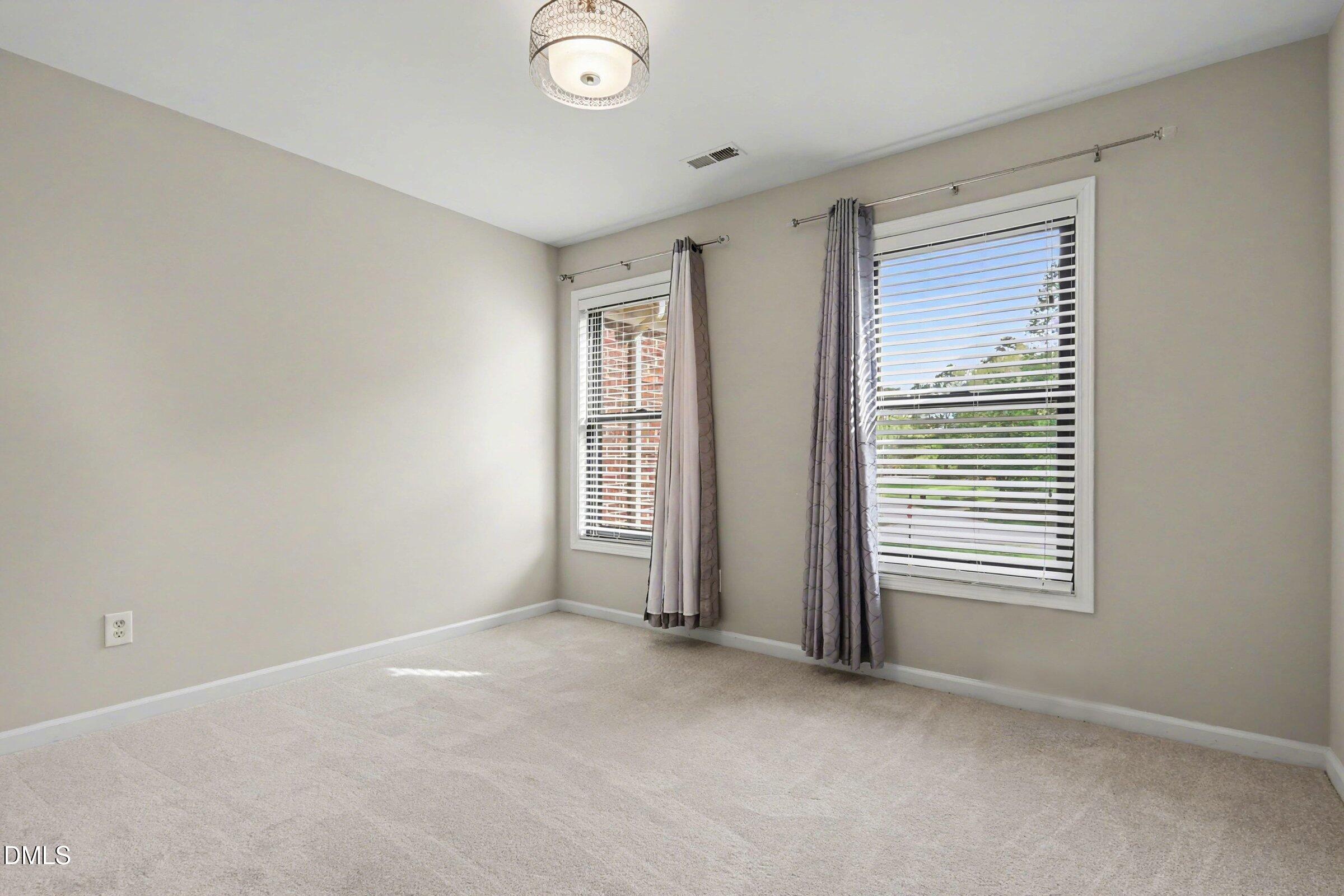 1001 Denfield Court Raleigh, NC 27615 - Photo 25 of 44 an empty room with windows