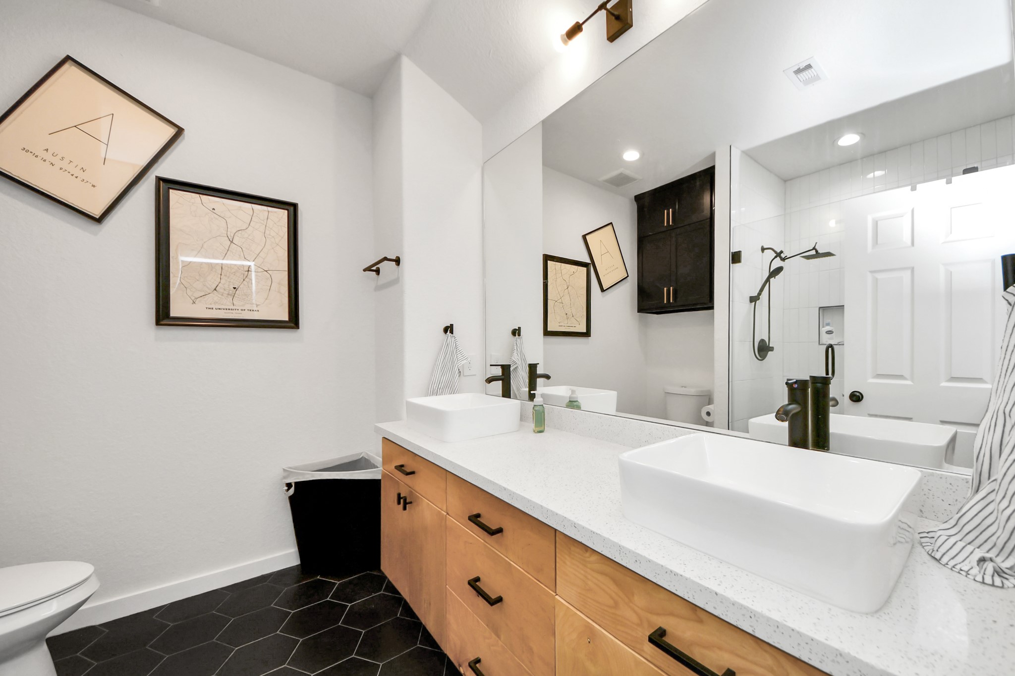 111 Jenkins Street Houston, TX 77003 - Photo 14 of 24 a spacious bathroom with a sink a toilet a mirror and shower