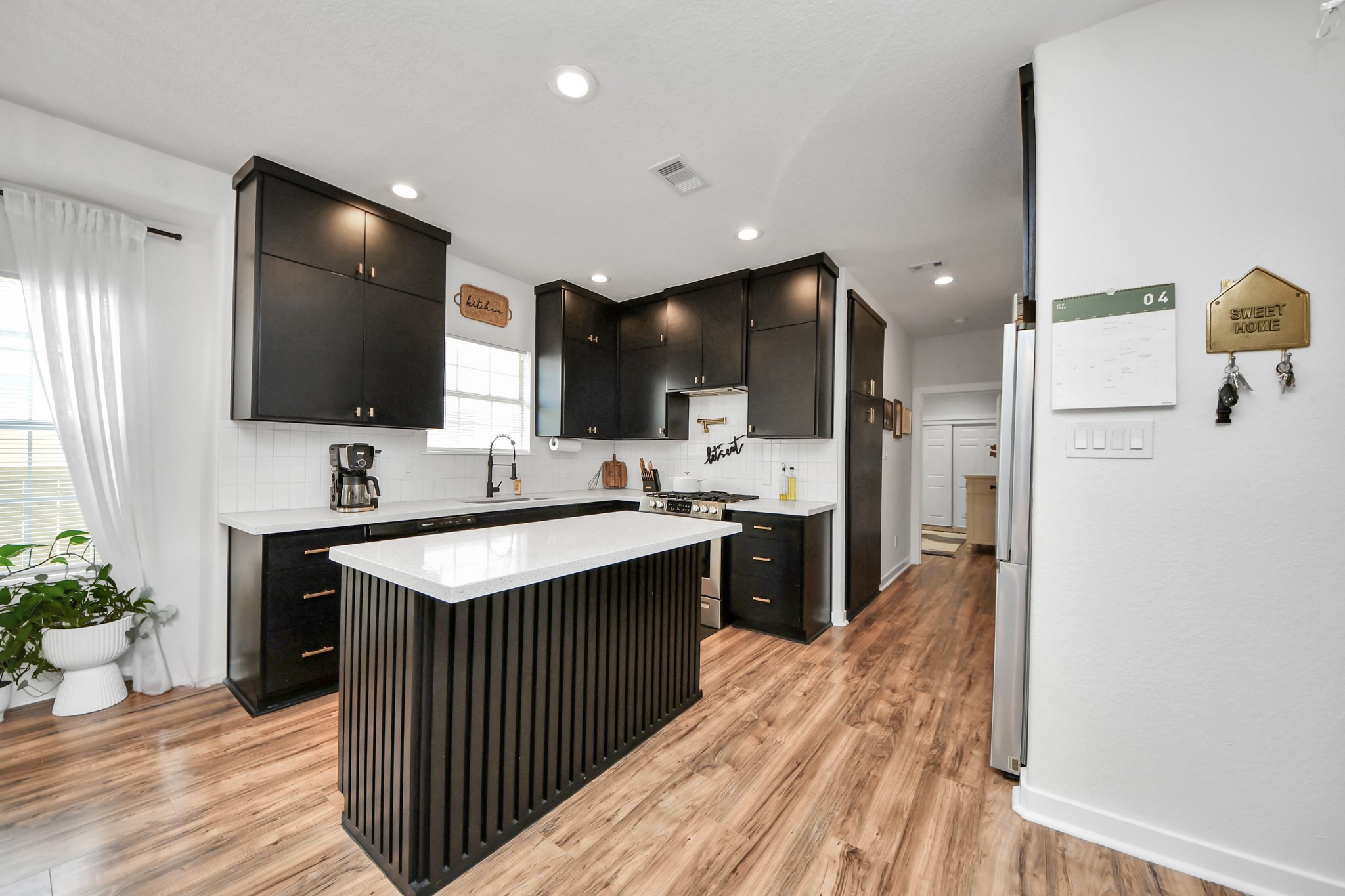 111 Jenkins Street Houston, TX 77003 - Photo 7 of 24 a kitchen with stainless steel appliances a sink and a refrigerator