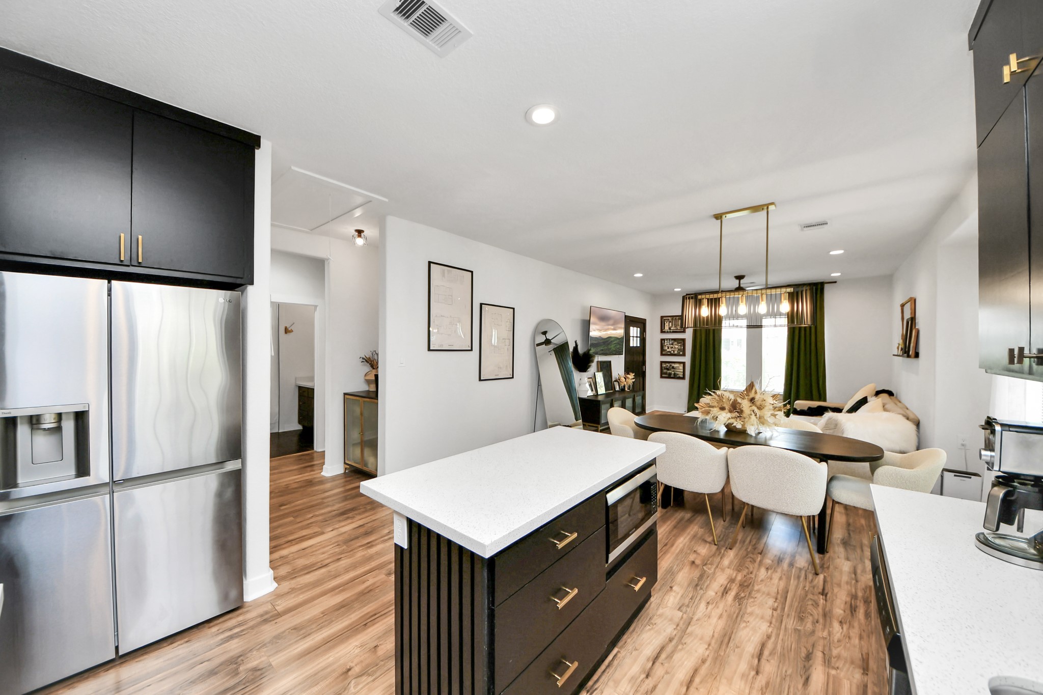 111 Jenkins Street Houston, TX 77003 - Photo 8 of 24 a kitchen with a refrigerator a counter space and wooden floor
