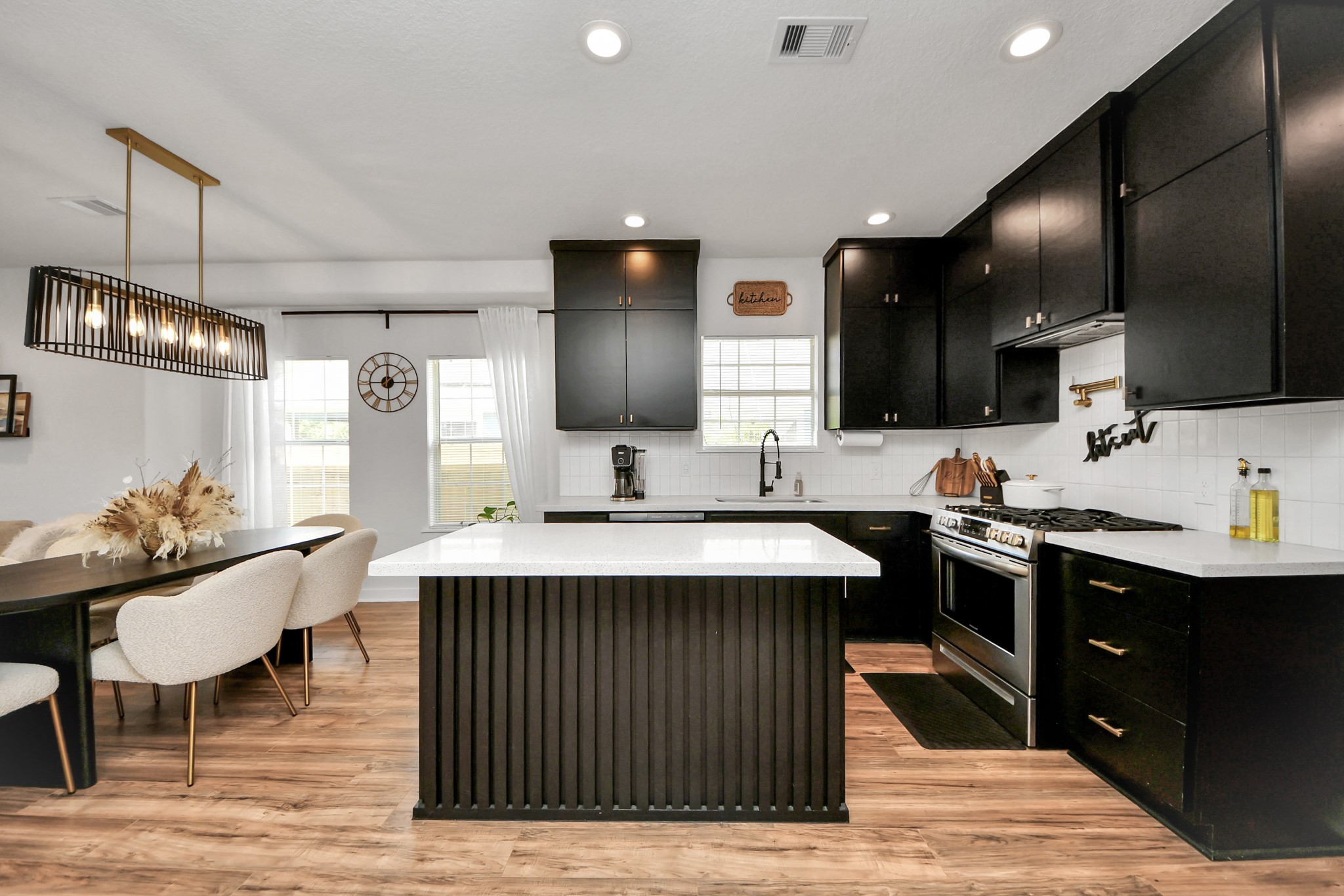 111 Jenkins Street Houston, TX 77003 - Photo 9 of 24 a kitchen with stainless steel appliances granite countertop a sink a stove and a wooden floors