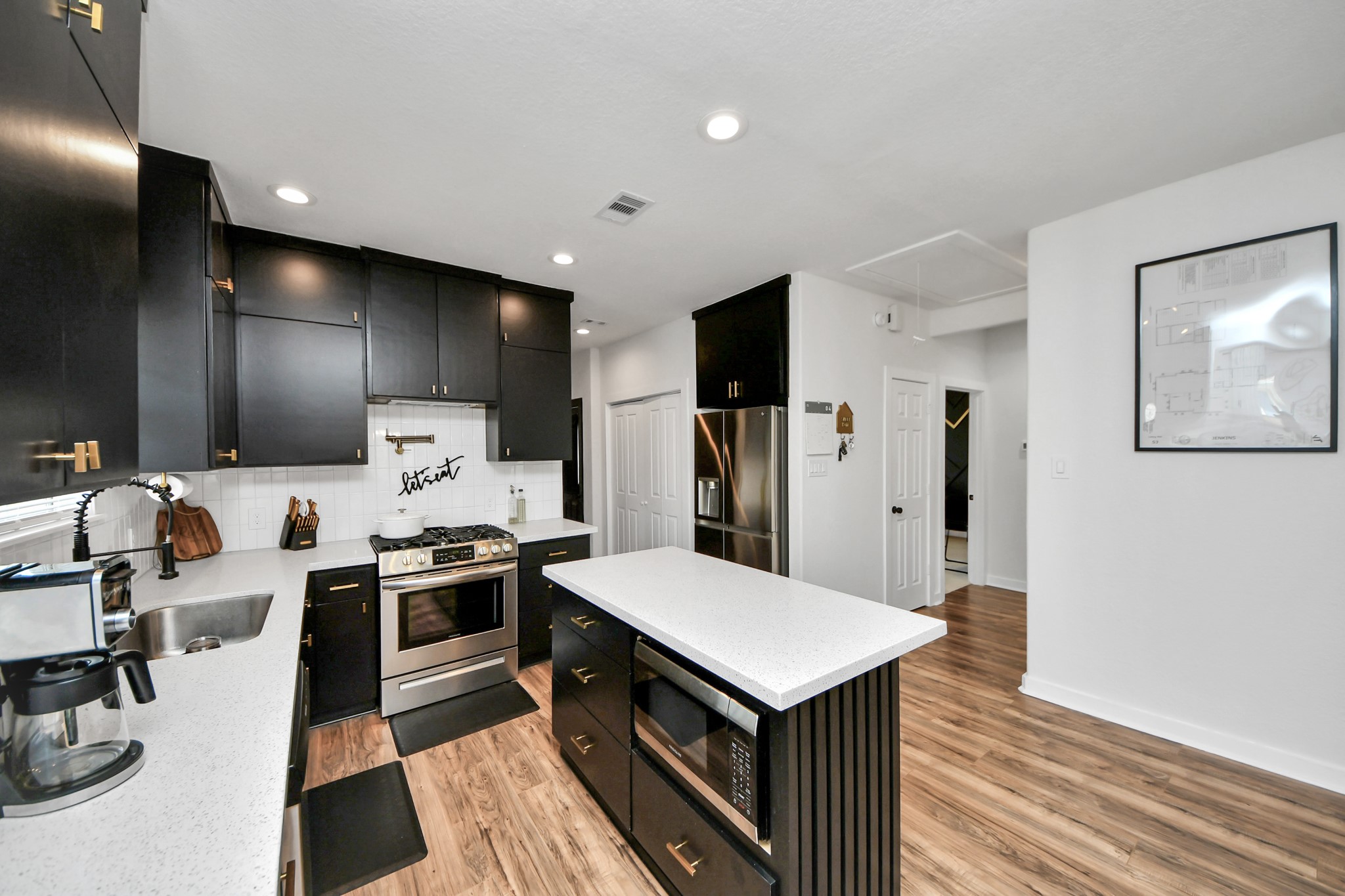 111 Jenkins Street Houston, TX 77003 - Photo 10 of 24 a kitchen with stainless steel appliances a stove refrigerator sink and microwave