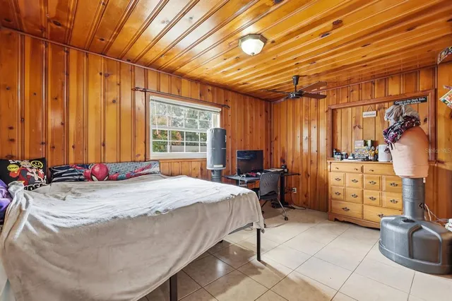 a bed sitting in a room next to a window