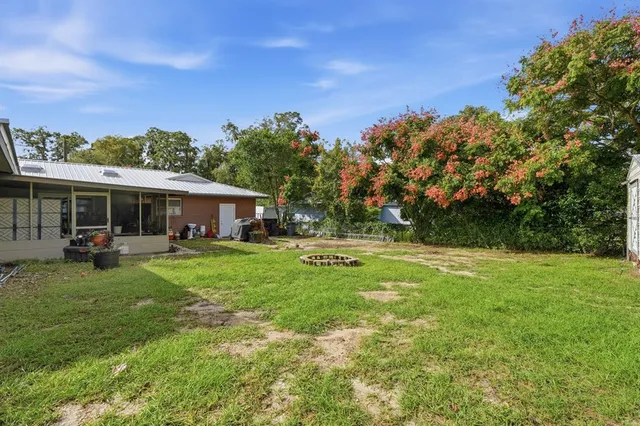 a backyard of a house with table and chairs