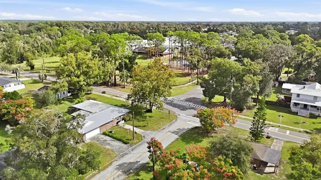 an aerial view of a house with a yard