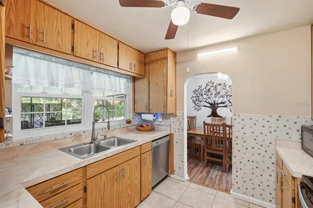 a kitchen with stainless steel appliances a sink a stove a refrigerator and cabinets