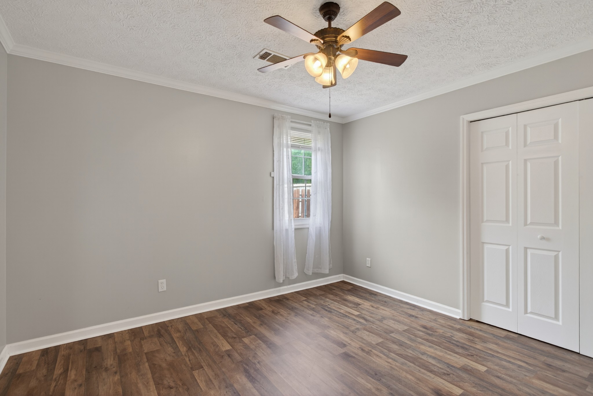 430 Walton Ferry Road, Unit 200 Hendersonville, TN 37075 - Photo 13 of 16 an empty room with wooden floor chandelier fan and windows