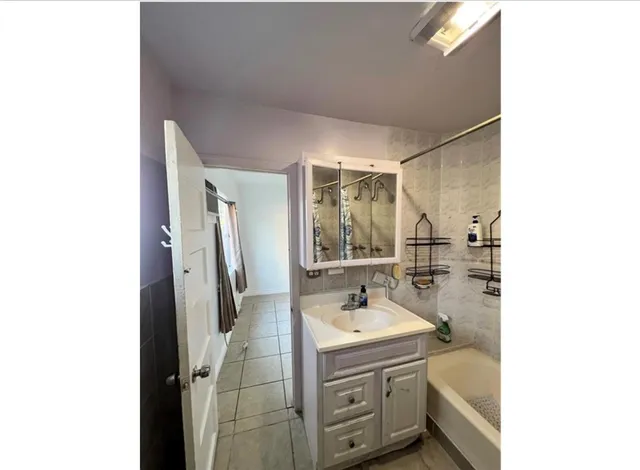 a view of a hallway with a chandelier fan and windows