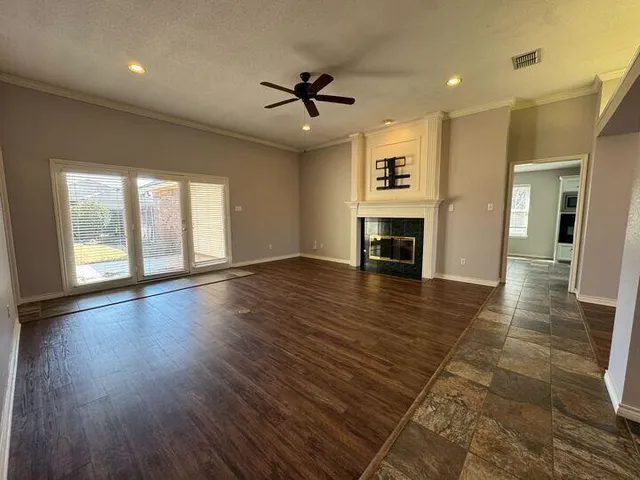 an empty room with closet and a ceiling fan