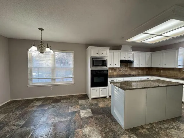 a kitchen with a cabinets and wooden floor